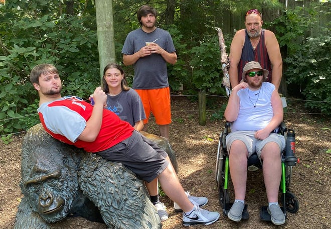 Presden Deal, seated right, and his father, Mike, enjoy a day at the Columbus Zoo with Presden’s brother and sister, Nathan and Sierra, and his “bonus brother,” Brady. Presden, age 21, was diagnosed with mitochondrial disease (myopathy) at the age of 2. His family and close friends have been his support group throughout his life.