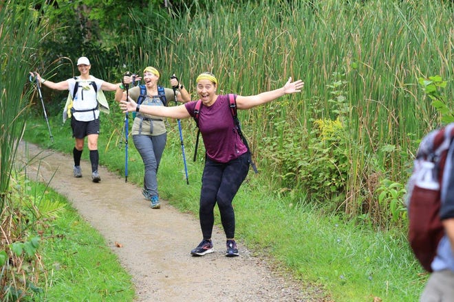 Hikers smile for the camera as they take part in a bygone mammoth march.