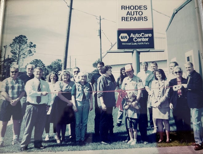This photo, of Rhodes Auto Repairs celebrating a ribbon cutting, still stands on the counter of the business.