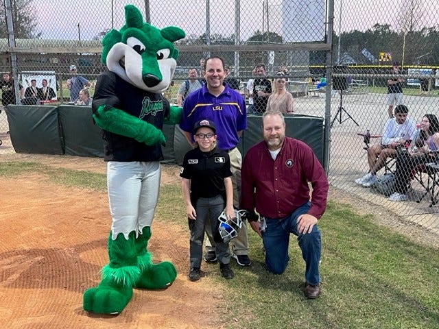 Lathan the Kid Umpire stops for a photo with Ascension Parish President Clint Cointment and Ricky Compton.