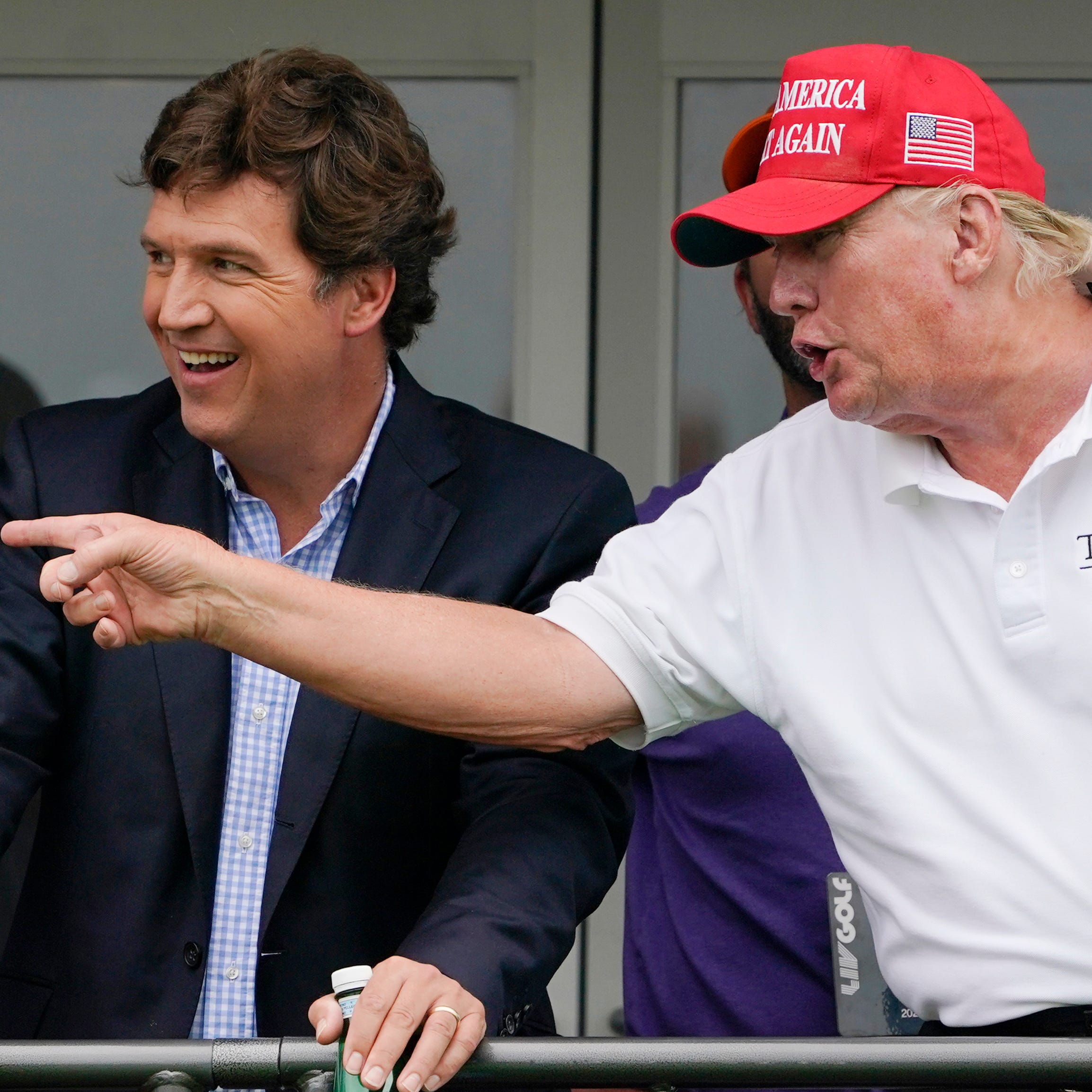 Fox News' Tucker Carlson and former President Donald Trump watch the LIV Golf Invitational at the Trump National Golf Club in Bedminster, N.J., on July 31, 2022.