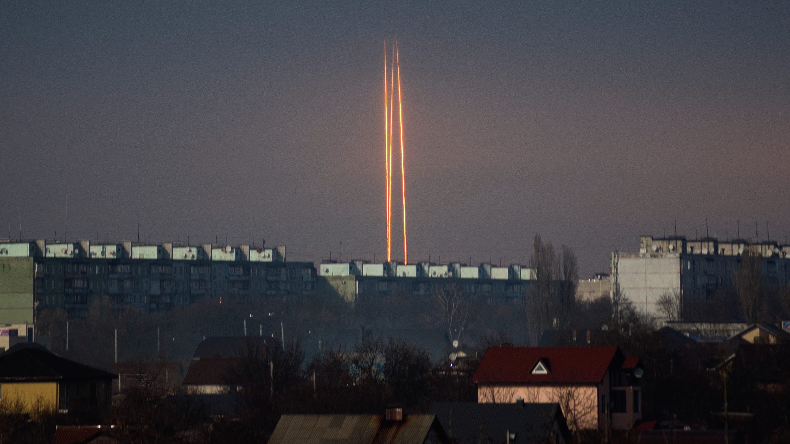 Three rockets launched against Ukraine from Russia's Belgorod region are seen at dawn in Kharkiv, Ukraine, Thursday, March 9, 2023.