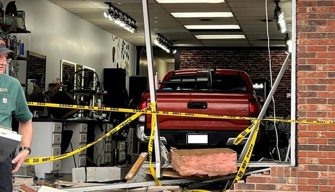 A truck sits in Studio 64 Hair Design at Henderson Crossing Plaza after plowing through the front entrance of the salon on March 9.