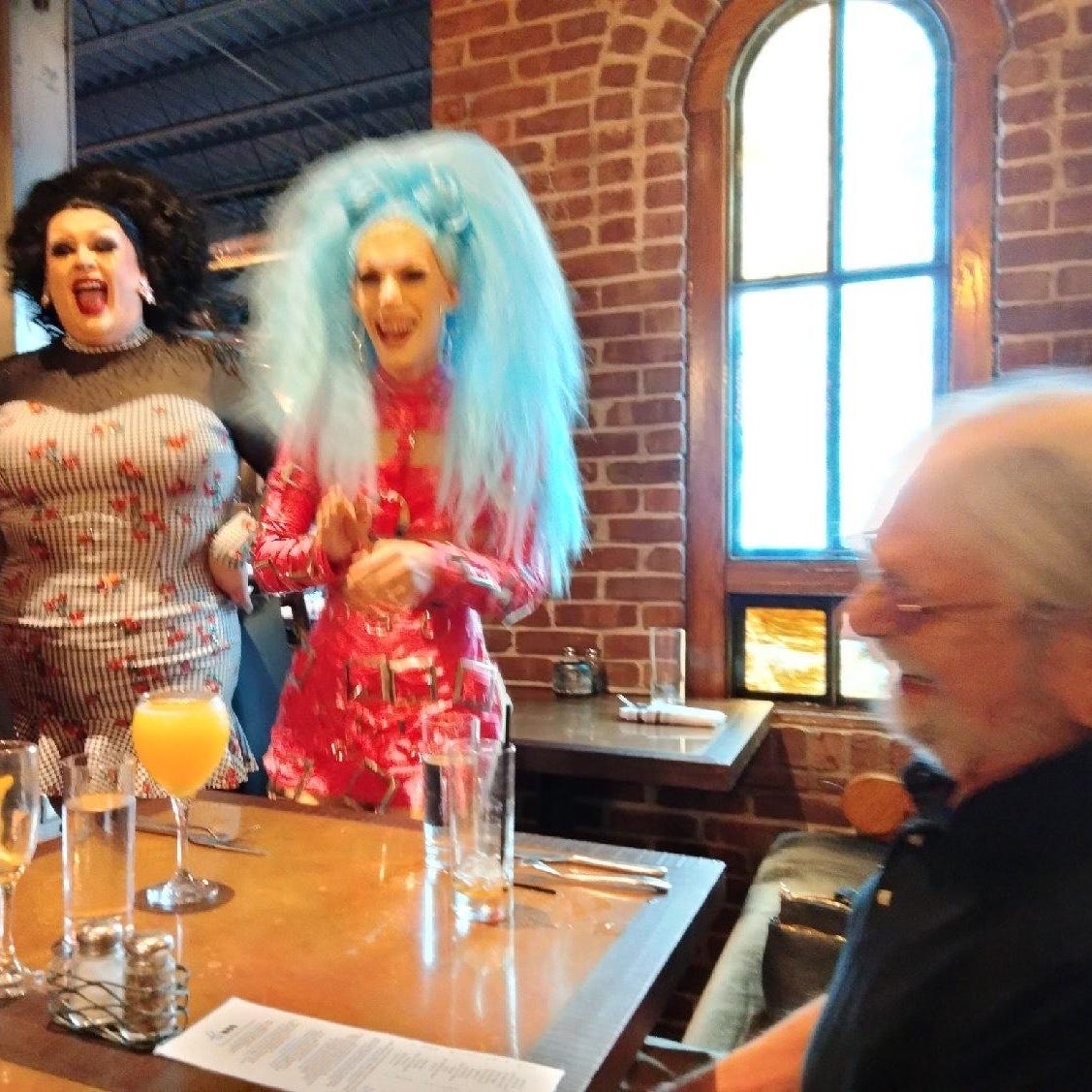 Tom Shafer, right, enjoying his 90th birthday at a drag brunch show in 2022.