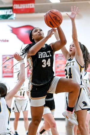 Holt's Janae Tyler scores against DeWitt during the third quarter on Thursday, March 9, 2023, at Coldwater High School.