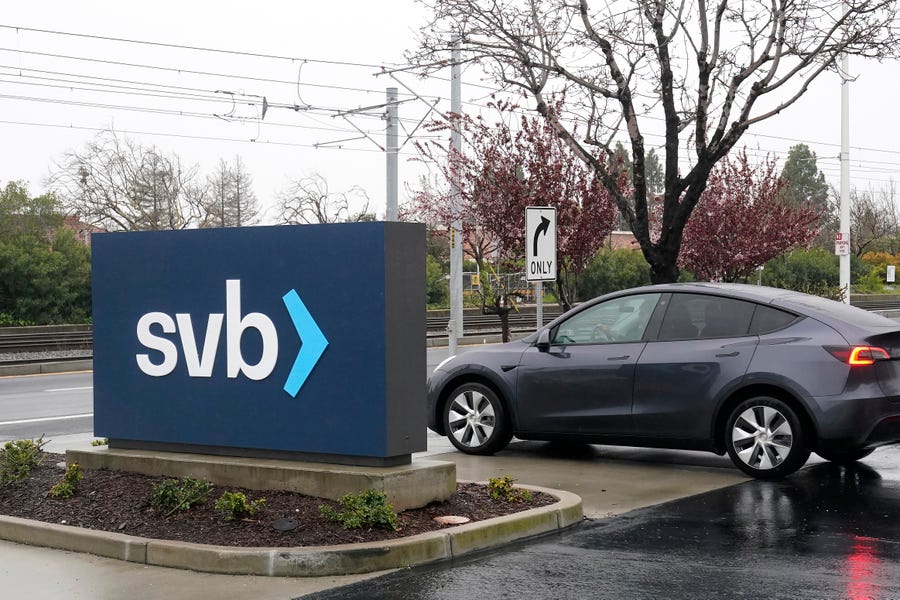 A car drives past a Silicon Valley Bank sign at the company's headquarters in Santa Clara, Calif., Friday, March 10, 2023. The Federal Deposit Insurance Corporation is seizing the assets of Silicon Valley Bank, marking the largest bank failure since Washington Mutual during the height of the 2008 financial crisis. The FDIC ordered the closure of Silicon Valley Bank and immediately took position of all deposits at the bank Friday. (AP Photo/Jeff Chiu)