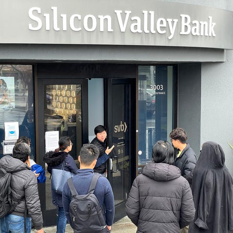 A worker tells people that the Silicon Valley Bank