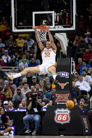 Texas forward Christian Bishop dunks the ball against TCU in the first half of a Big 12 semifinal at T-Mobile Center in Kansas City. Bishop, who grew up in the area, had 15 points while helping Texas beat the Frogs 66-60.