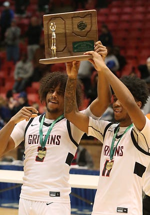 Buchtel's Amire Robinson and Marcel Boyce Jr. hold up the trophy after after a win over Gilmour Academy in a regional final, Saturday, March 11, 2023, in Canton.