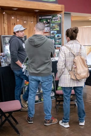 Guests at the Home, Garden and Business Expo take some time to speak with Dutch Barn Builders.