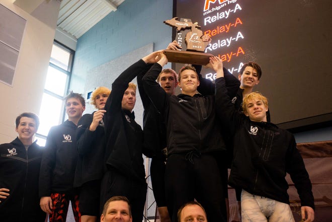West Ottawa accepts their second place trophy during the Division 1 state swim and dive finals Saturday, March 11, 2023, at Calvin University. 