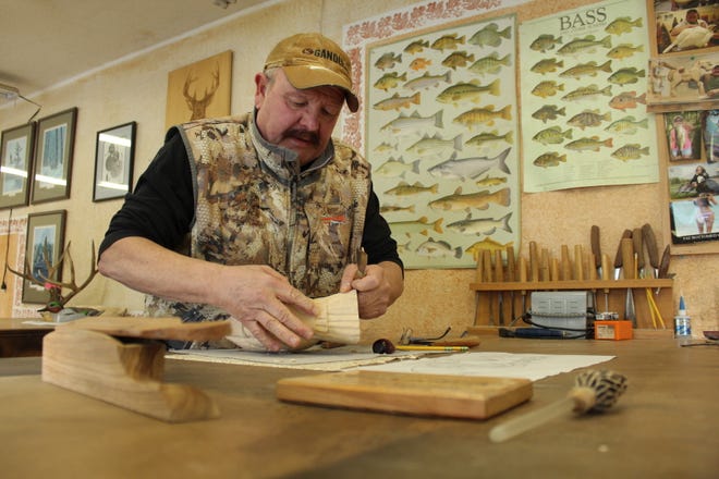 Dave Constantine of Durand carves a turkey out of a block of basswood in his workshop. In February, Constantine was inducted into the Grand National Custom Call Competition Hall of Fame.