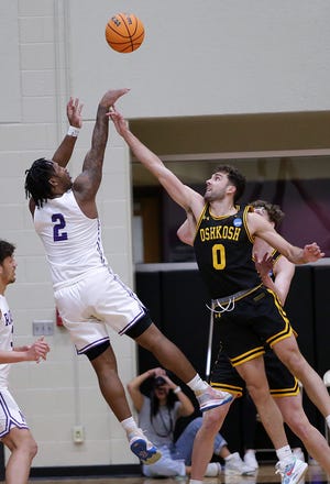 Mount Union's Collen Gurley (2) puts up a shot over Oshkosh's Eric Peterson in an NCAA Division III Elite 8 game, Saturday, March 11, 2023.