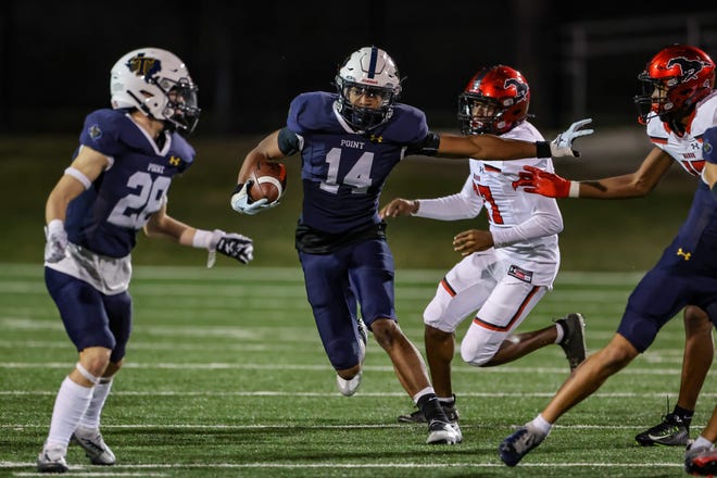 Senior Braylon James (14), a Notre Dame commit, and Stony Point work to stiff arm their way through Manor defenders Nov. 4 at Kelly Reeves Athletic Complex
