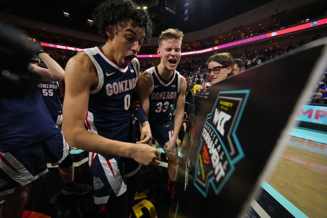 Gonzaga Bulldogs guard Julian Strawther (0) and forward Ben Gregg (33) celebrate against the Saint Mary's Gaels after the game in the finals of the WCC Basketball Championships at Orleans Arena in Las Vegas on March 7.