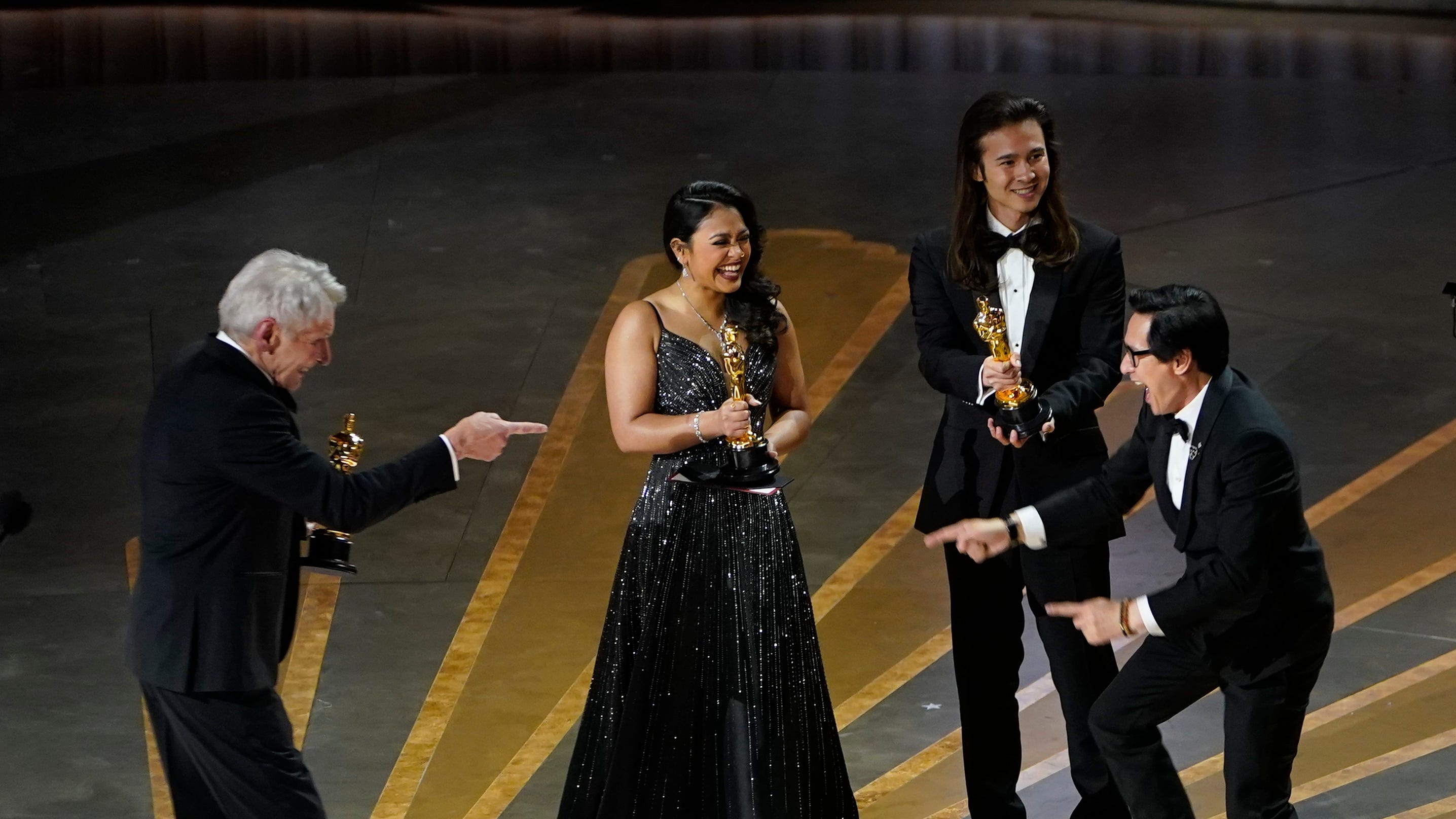 Presenter Harrison Ford celebrates with Ke Huy Quan as "Everything Everywhere All at Once" wins the award for best motion picture.