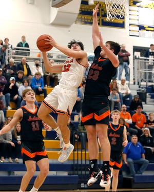 Charlotte's Braden Hill goes up for a shot while defended by Tecumseh's Ryder Zajac during Monday's Division 2 regional semifinal at Chelsea.