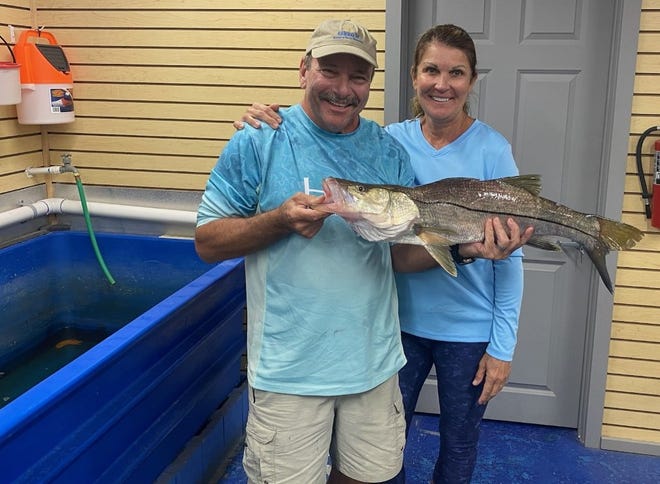 Pat Laurenti, with his wife, Dena, show off a Snook that checked in at 9-plus pounds.  He was caught last week in the Tomoka River under the Old Dixie Highway Bridge.