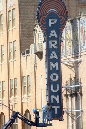 The iconic Paramount Theatre sign got a cleaning Monday, both sides, from David Reynaud. He was preparing the sign for restoration; Reynaud did the restoration on the Dino Bob sculpture downtown. A little cool with a north wind blowing, it was fine day otherwise for the project. The temperature will be in the 70s the next two days, with wind and a chance of thunderstorms, before turning much colder for St. Patrick's Day on Friday.