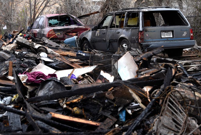 Burned-out cars sit amide the rubble of a home destroyed in a Monday night fire. The home in the 2700 block of South 10th Street was deemed a total loss.