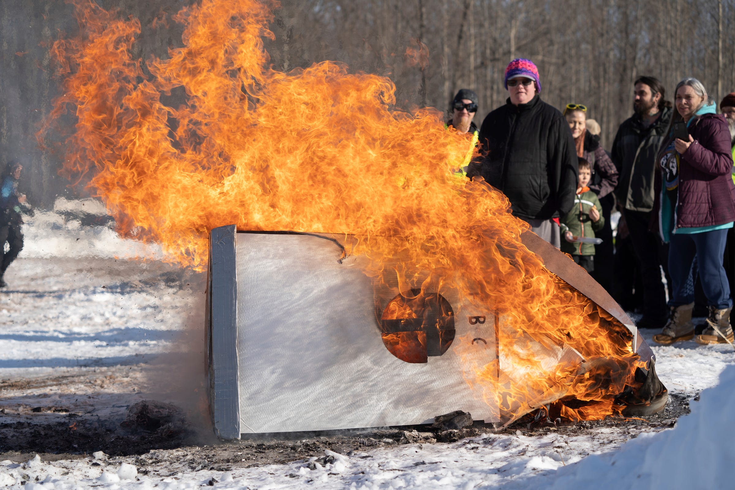 A church-shaped cardboard sled made by members of the First Baptist Church of Gwinn burns in a post-race bonfire at the K.I. Sawyer Cardboard Sled Races on Feb. 11, 2023.