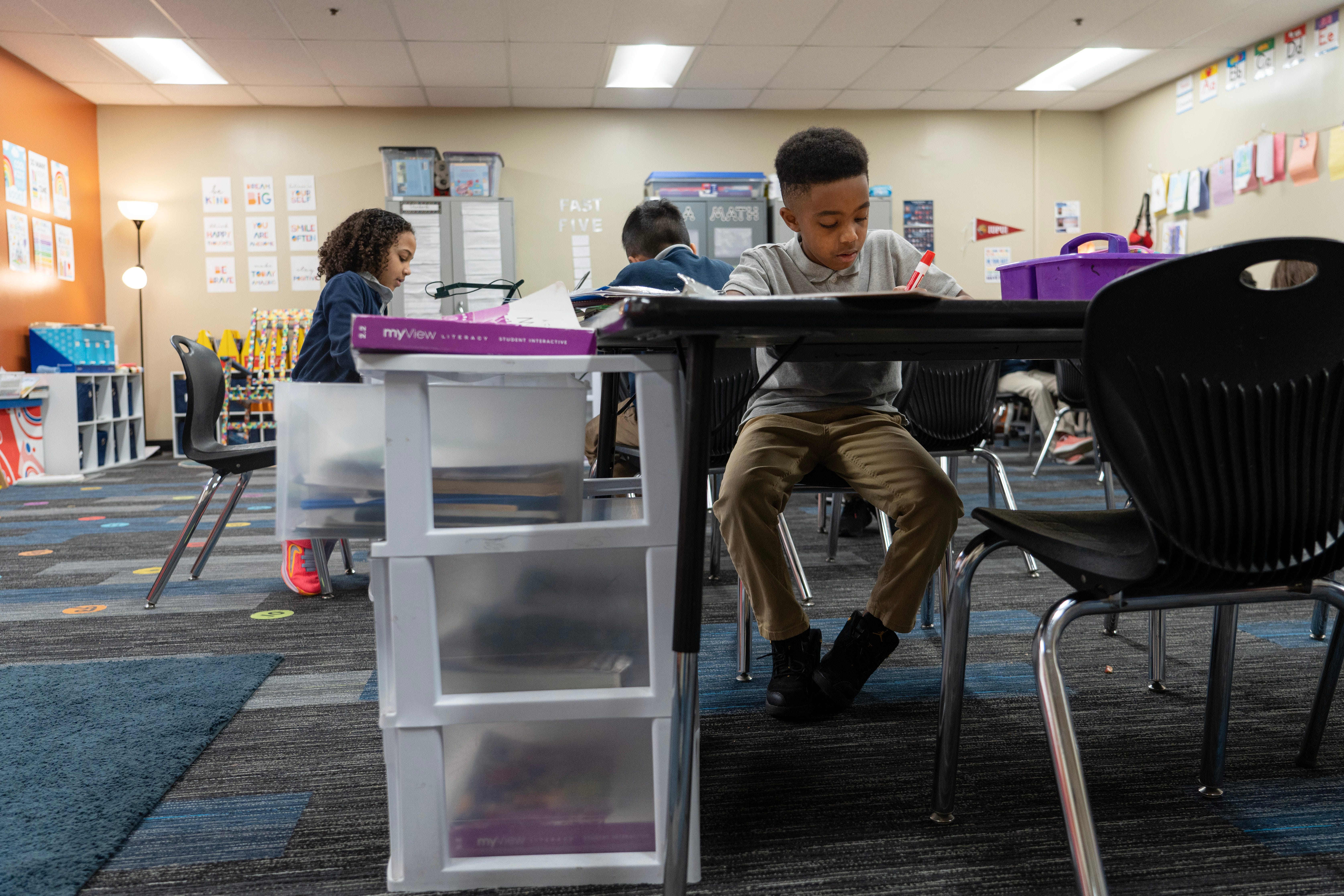 Jhace Moore, 8, spends his morning learning homophones and homonyms Monday, March 13, 2023, in his second grade class at Paramount Brookside Charter School in Indianapolis. Moore and his family were left scrambling looking for a school after his old one, Him by Her Charter School, shut down suddenly in January. 