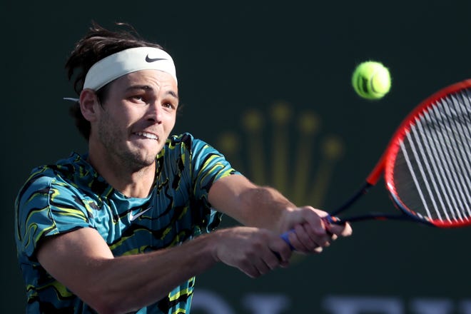 Taylor Fritz returns to Sebastian Baez during the BNP Paribas Open in Indian Wells, Calif., on Monday, March 13, 2023. Fritz won in straight sets. 