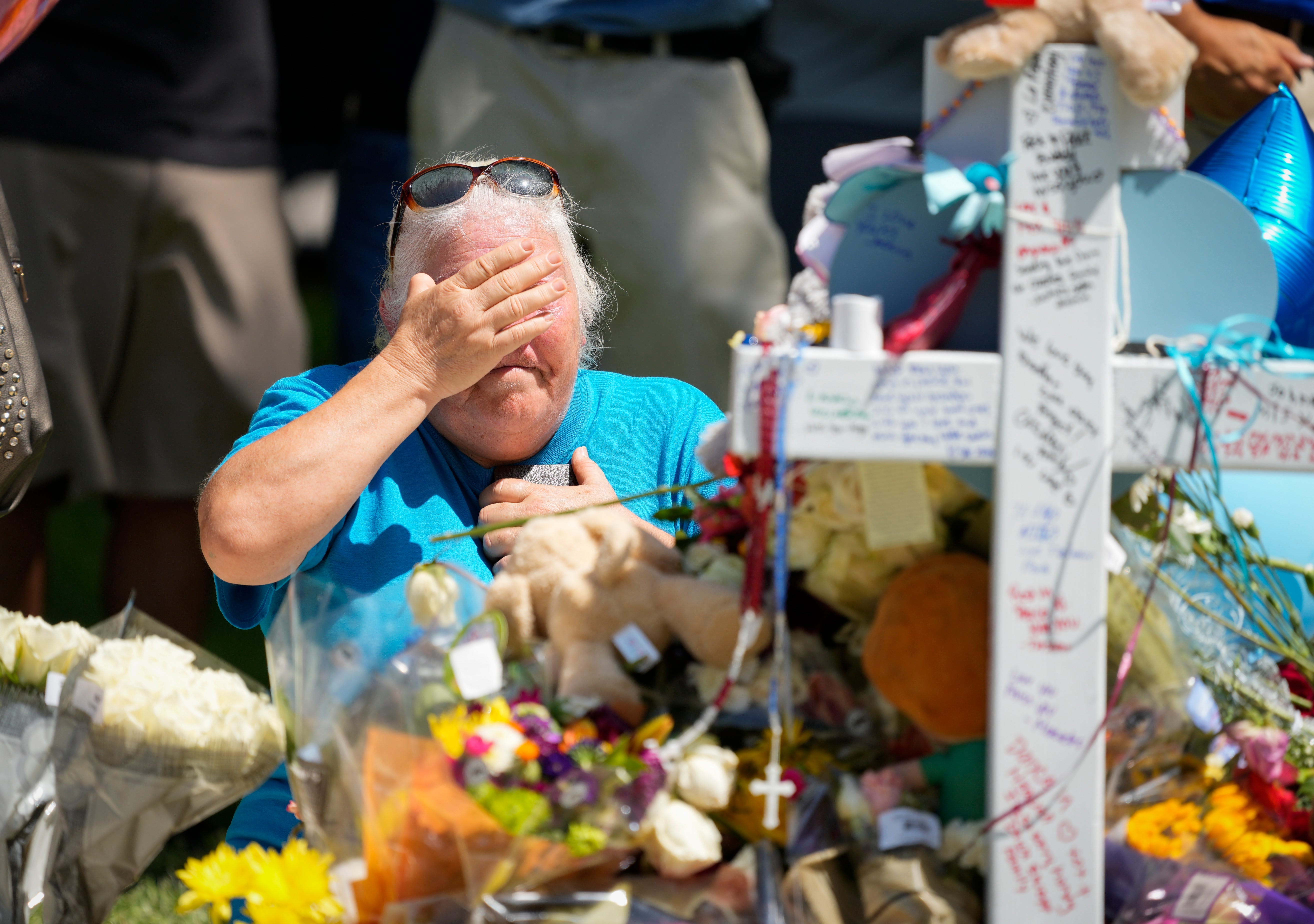 People visit the town square in Uvalde, Texas, to view a memorial with the names of the 19 children and two teachers killed in the mass shooting at Robb Elementary School.