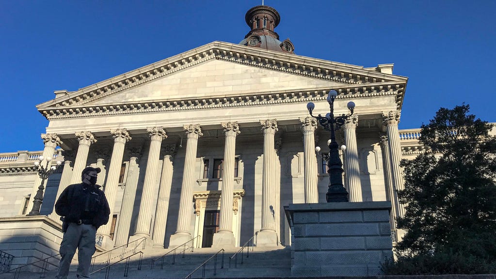 South Carolina Law Enforcement Division and other state law enforcement guard the perimeter of a barricaded South Carolina State House in Columbia on Monday, Jan. 18, 2021