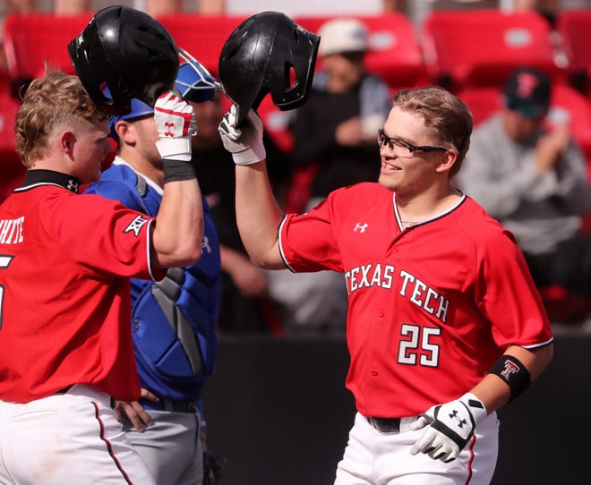 Texas Tech's Hudson White and Owen Washburn (25) tap helmets after Washburn homered in the eighth inning and of the Red Raiders' 14-7 home victory Wednesday against Texas-Arlington. White followed Washburn with back-to-back homers.