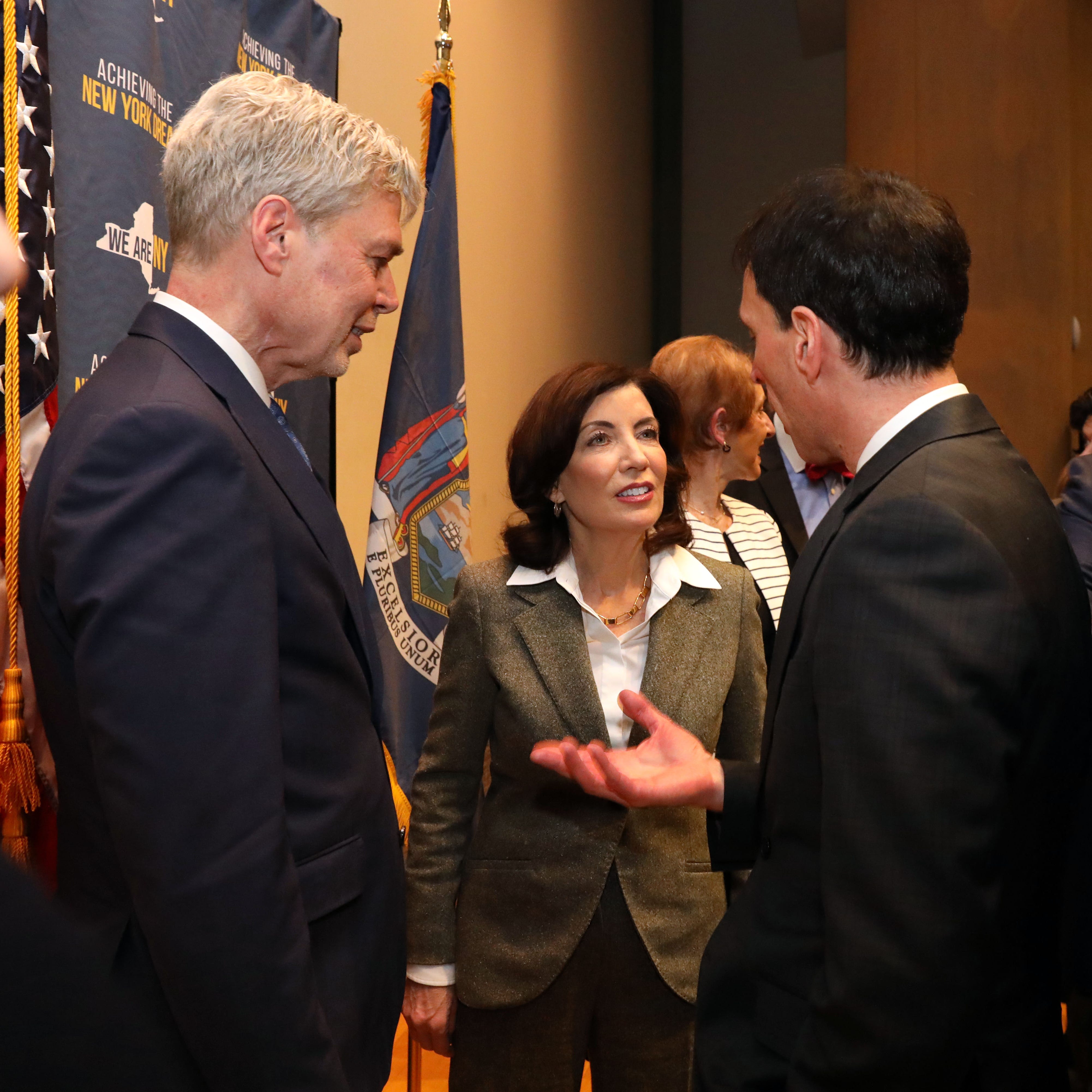 Gov. Kathy Hochul chats with New Rochelle Mayor Noam Bramson, right, and White Plains Mayor Tom Roach after speaking about the state's housing crisis with Westchester business leaders at the Business Council of Westchester in Rye Brook March 15, 2023.