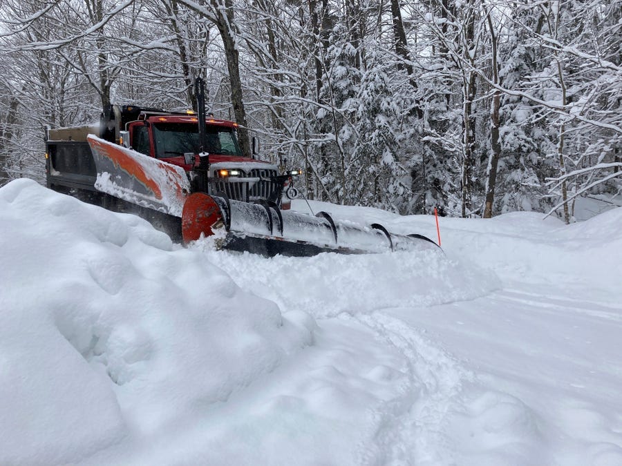 A plow truck moves snow off a back road in Marshfield, Vt., on Wednesday, March 15, 2023.