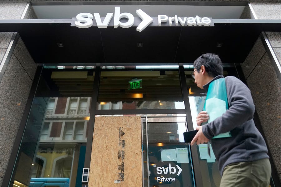 A pedestrian passes a Silicon Valley Bank branch in San Francisco.