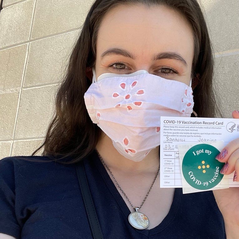 Jeanine Santucci showing her vaccine card.
