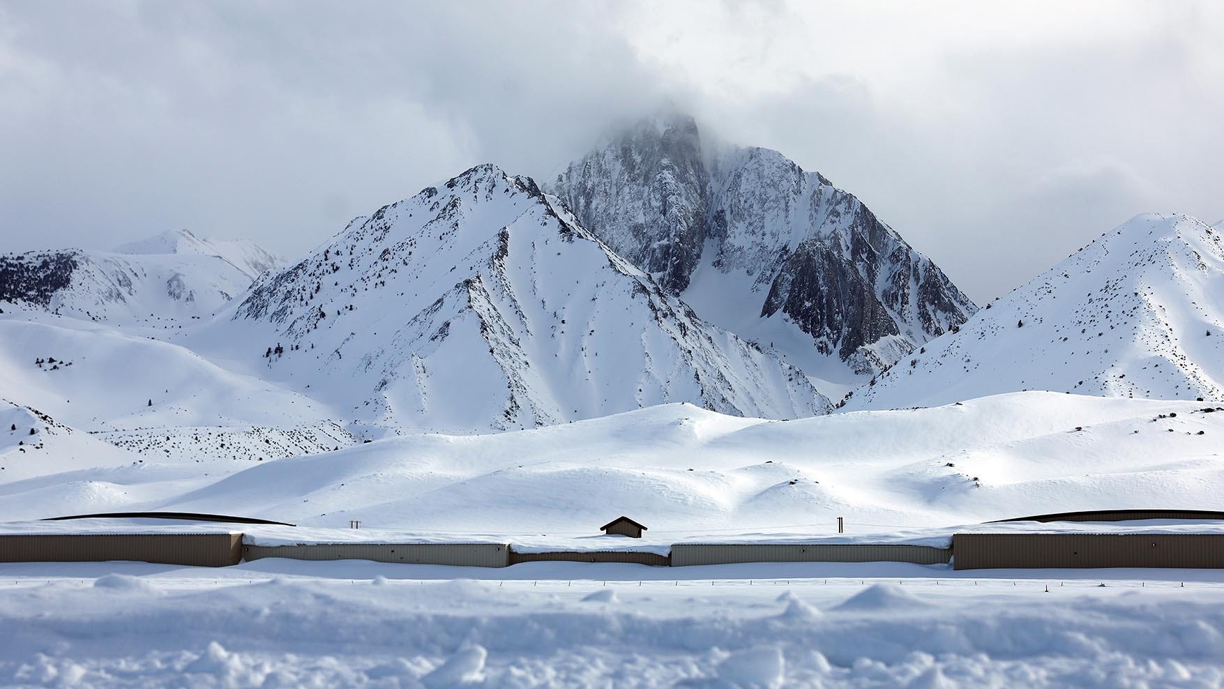 Clouds pass above the snow-covered Sierra Nevada mountains in the wake of an atmospheric river event which brought heavy snow to higher elevations on March 12, near Mammoth Lakes, California.