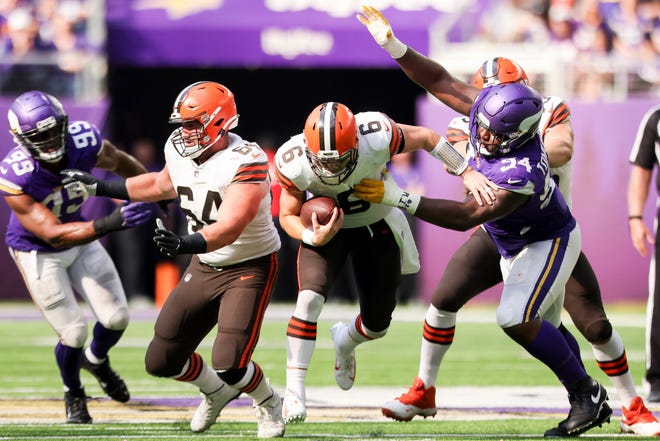 Minnesota Vikings defensive end Dalvin Tomlinson (94) tackles Cleveland Browns quarterback Baker Mayfield (6) during an NFL football game, Sunday, Oct. 3, 2021 in Minneapolis. Cleveland won 14-7. (AP Photo/Stacy Bengs)