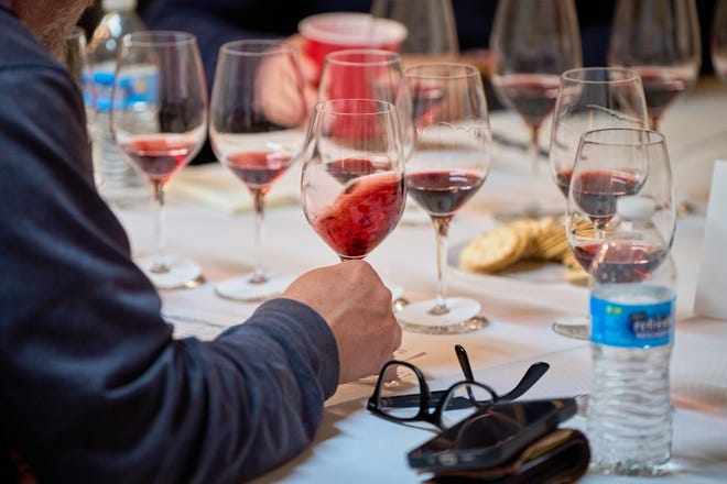 A wine judge swirls a red wine during the 2023 azcentral Arizona Wine Competition on Feb. 27, 2023, at The Newton in Phoenix.