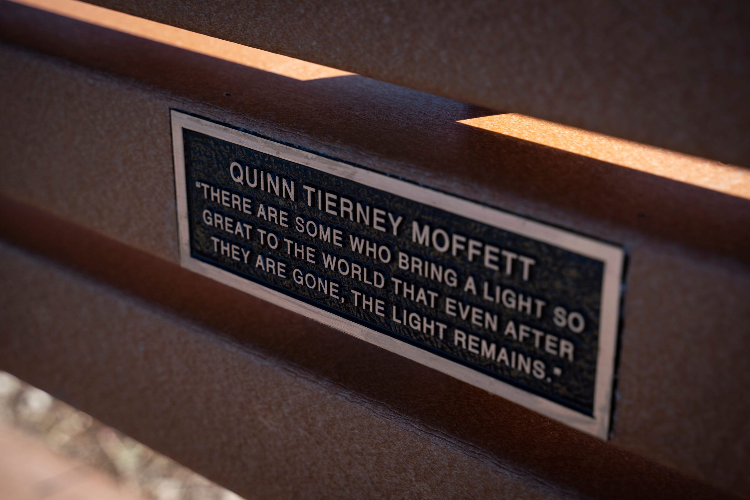 A bench made by family and friends to honor Quinn Moffett sits near a path in Ann Arbor on Wednesday, March 16, 2023. In 2021, Moffett died at 21 from an accidental overdose while battling depression and anxiety after being sexually assaulted.