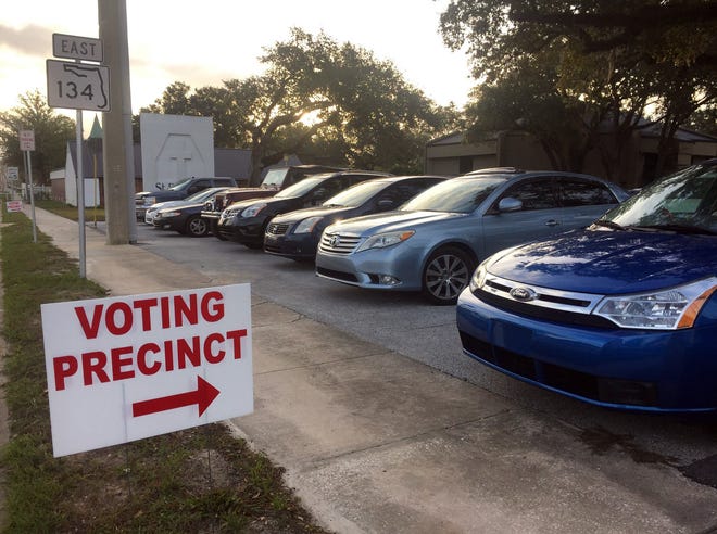 Voters' cars fill the parking lot for a Jacksonville voting precinct in this 2016 photo.