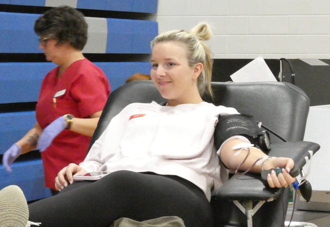 Mackenzie Tarbert, a Wynford High School senior, donates blood on Friday in the school’s gymnasium during a special “Kind Like Keris” blood drive in memory of her cousin, Keris Dilgard Riebel. Riebel was killed in January at her workplace in Upper Sandusky.
