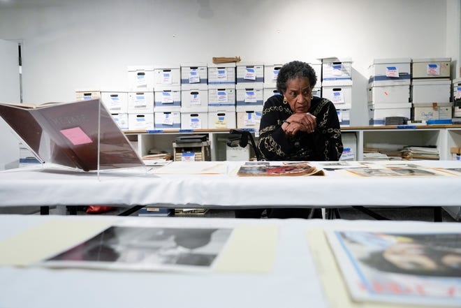 Myrlie Evers-Williams looks over some personal photographs and magazines that she donated to her alma mater, Pomona College.