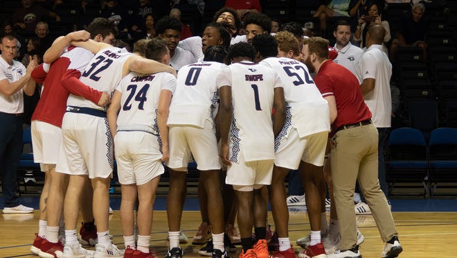 The USI men's basketball team huddles prior to tipoff at the CBI.