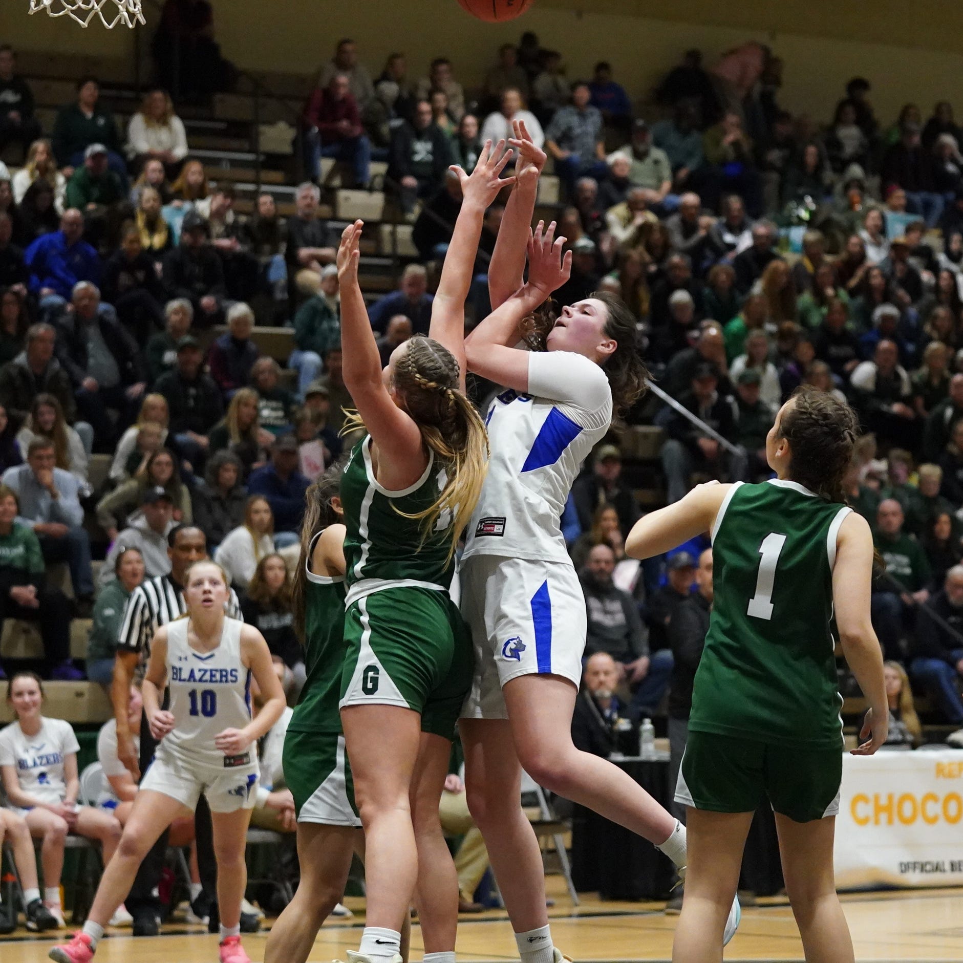 Millbrook's Natalie Fox (21) puts a shot over several Greenwich players in the girls Class C state semifinal game at Hudson Valley Community College in Troy, on Saturday, March 18, 2023.