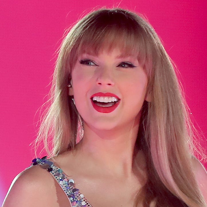 Taylor Swift smiles at the 70,000 fans at State Farm Stadium outside of Phoenix at the kickoff of her Eras Tour on March 17, 2023.