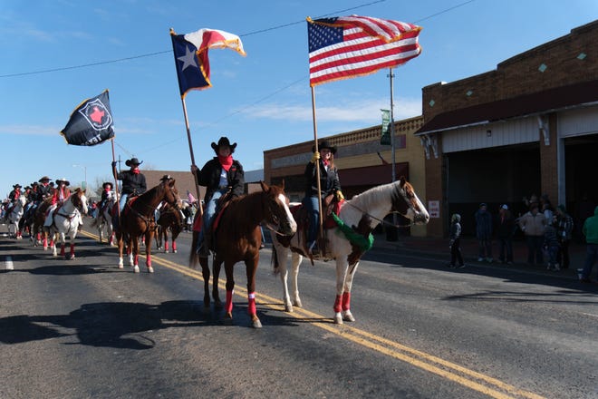 The Randall County Sheriff's Posse is greeted by the crowd Saturday during the 76th annual St. Patrick's Day Parade in Shamrock, Texas.