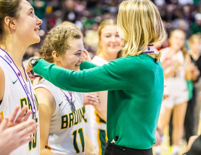 Bruins Coach Jill Nagel puts the 2nd place medal around Rock Bridge's Bella Corrado following the Class 6 girls championship basketball game on Saturday, March 18, 2023, at Missouri State University in Springfield, Mo.   Incarnate Word defeated Rock Bridge 57-30 for the championship and its 100th consecutive victory.