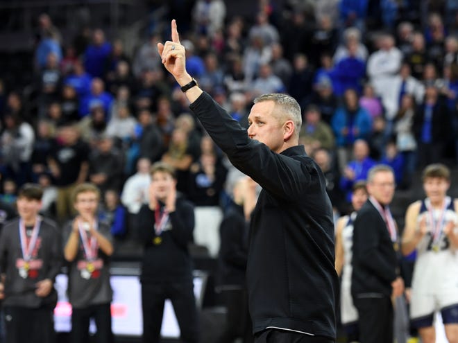 Dakota Valley head coach Jason Kleis points to the fans in the stands as he steps forward to receive the class A championship trophy on Saturday, March 18, 2023, at the Denny Sanford Premier Center in Sioux Falls.