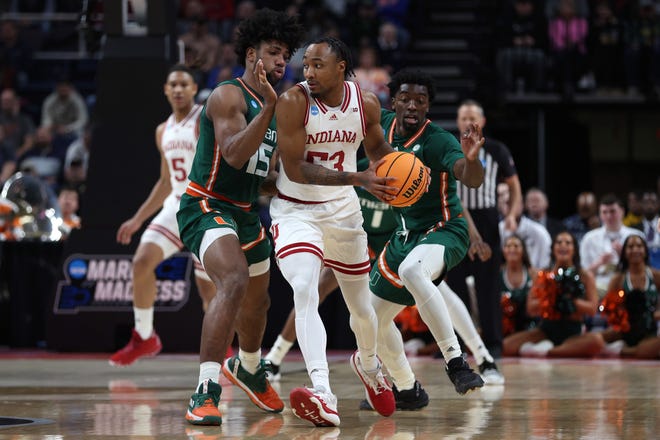 ALBANY, NEW YORK - MARCH 19: Tamar Bates #53 of the Indiana Hoosiers handles the ball against Norchad Omier #15 and Bensley Joseph #4 of the Miami Hurricanes in the first half during the second round of the NCAA Men's Basketball Tournament at MVP Arena on March 19, 2023 in Albany, New York.