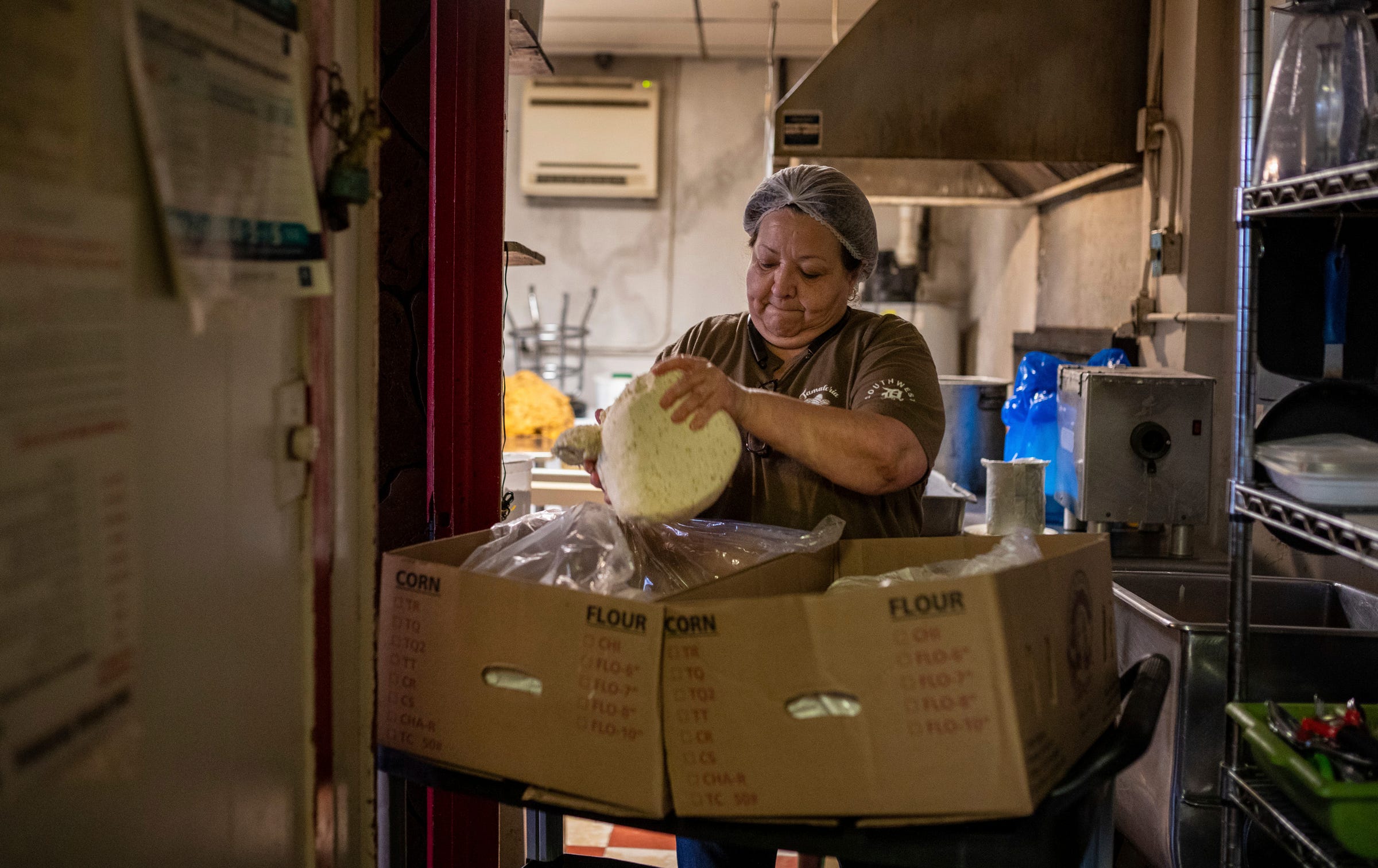 Tamaleria Nuevo Leon owner Susana "Suzy" Villarreal-Garza picks up a large piece of masa, a dough made of maize, inside Tamaleria Nuevo Leon in southwest Detroit on Friday, March 3, 2023. 