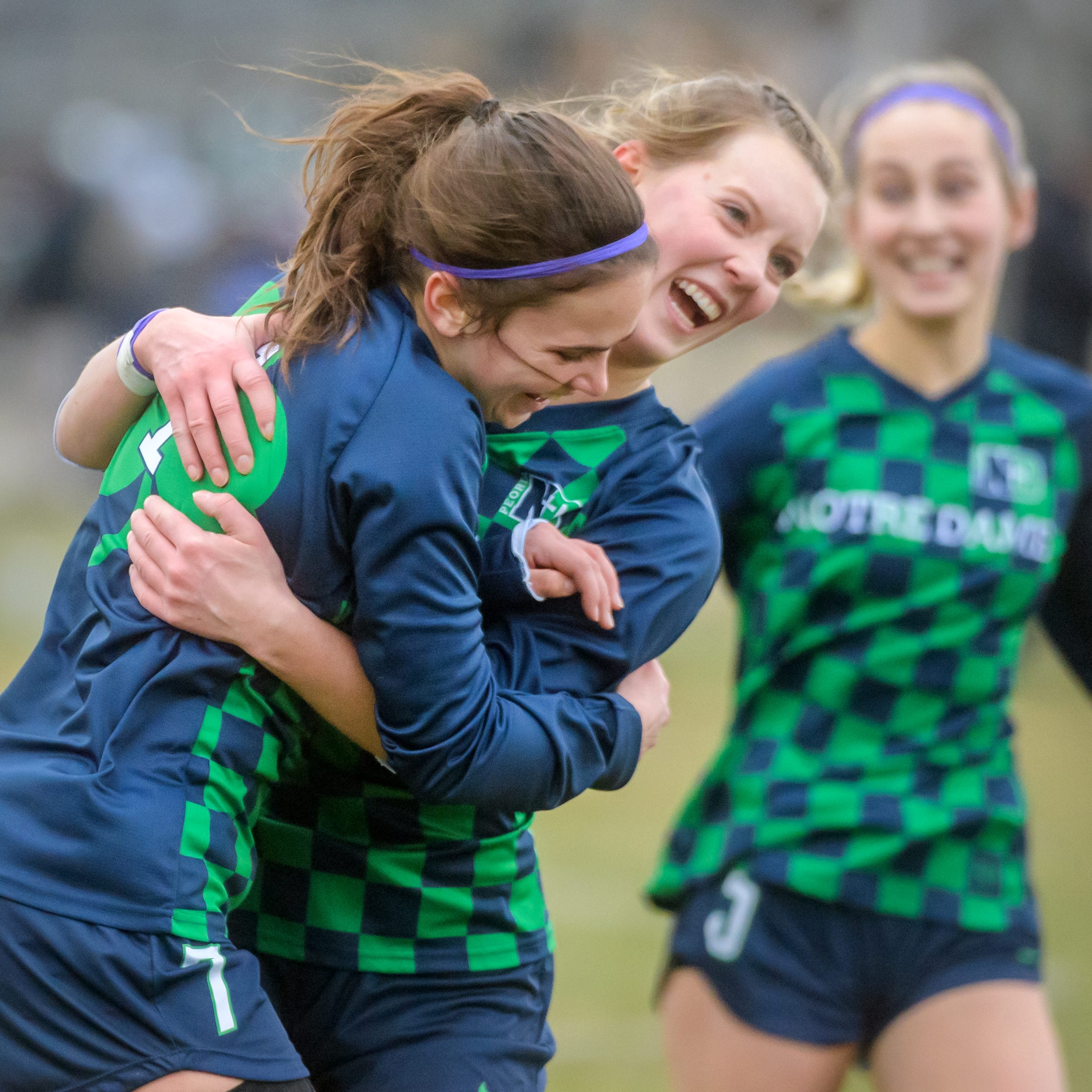 Peoria Notre Dame's Elly Bare, facing, celebrates teammate Maddie Stickelmaier's goal off a corner kick against Washington in the first period Tuesday, March 21, 2023 at PND High School. The Irish defeated Washington 3-0.